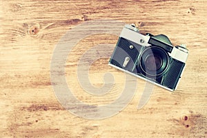 Vintage old camera on brown wooden background. room for text.