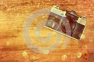 Vintage old camera on brown wooden background. room for text.