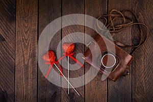 Vintage old camera with hearts on rustic wooden background. Top view