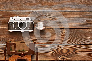 Vintage old camera and lens on wooden background