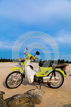 Vintage old classic green motorbike park on the beach