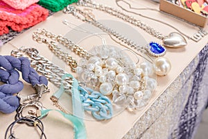 Vintage old-fashioned jewelry at flea market stall or car boot sale. Retro style pearl necklace