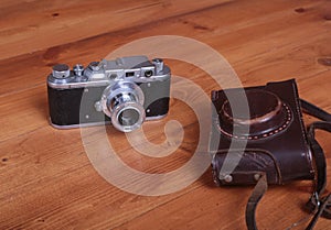 Vintage old film photo-camera in leather case