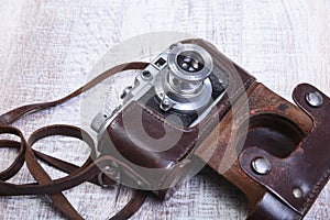 Vintage old film photo-camera in leather case