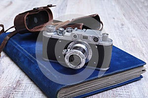 Vintage old film photo-camera in leather case and album