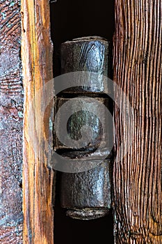 Vintage old hinge holding a large door