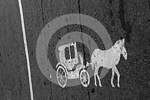Vintage old horse carriage painted transportation sign on asphalt road in city of Kuala Lumpur