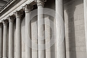 Vintage Old Justice Courthouse Column. Neoclassical colonnade with corinthian columns as part of a public building