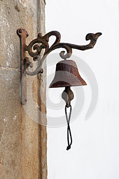 Vintage old metal bell hang on stone arch