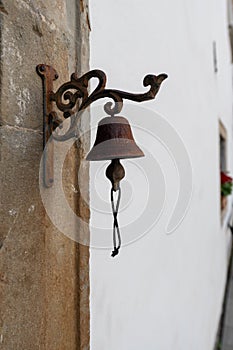 Vintage old metal bell hang on stone arch