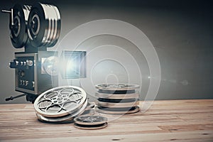 Vintage old movie camera and film cartridge on a wooden table