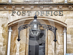 Vintage old post office building with sign on entrance