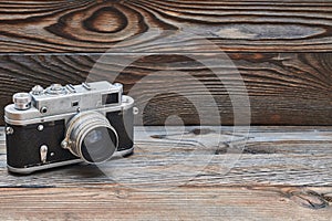 Vintage old retro rangefinder camera on wooden background