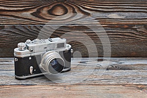 Vintage old retro rangefinder camera on wooden background