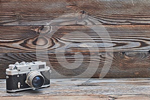 Vintage old retro rangefinder camera on wooden background