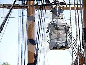 Vintage old sailboat lantern with mast and ropes