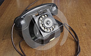 Vintage old telephone on wooden desk. technology of yesteryear