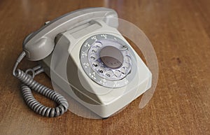 Vintage old telephone on wooden desk. technology of yesteryear