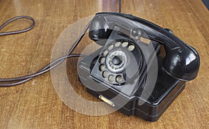 Vintage old telephone on wooden desk. technology of yesteryear