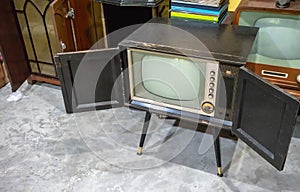 Vintage old television on concrete floor in the room