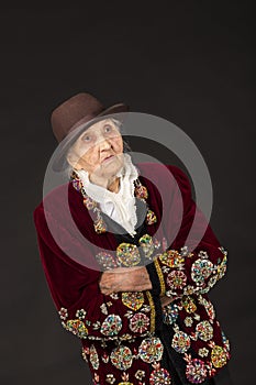 Old woman wearing a vermilion velvet jacket photo