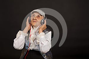 Vintage old woman in glitter with headphone