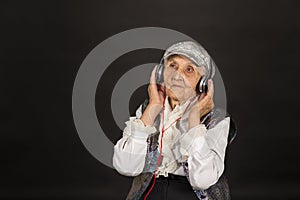 Vintage old woman in glitter with headphone