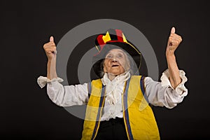 Vintage old woman wearing cylinder and a yellow vest