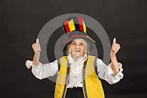 Vintage old woman wearing cylinder and a yellow vest