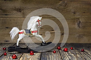 Vintage - old wooden rocking horse on a wooden old board for a c