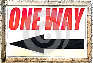 Vintage one way sign with black arrow showing direction