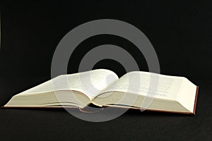 Vintage open book, black background, side view, black background