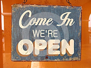 Vintage open sign board word `Come in We`re Open`