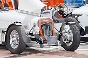 vintage open-top car at the yacht show in Monaco on a sunny day, leather seats, spoked wheels, close-up