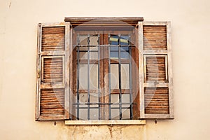 Vintage opened brown wooden shutters on a window