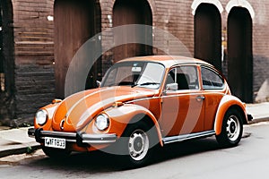 Vintage orange car on the street of the old city,  Retro style