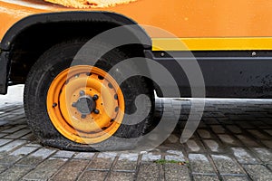 Vintage orange minibus with a flat wheel
