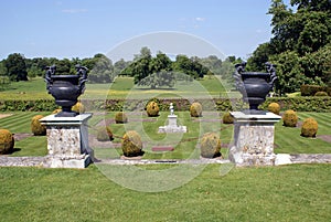 Vintage ornaments on pedestals in a topiary garden