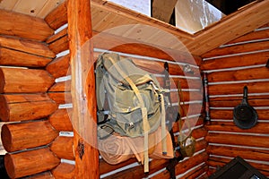 Vintage outdoor venture equipment on log cabin