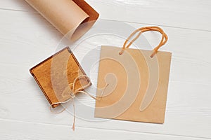 Vintage package and wooden box with wrapping kraft paper on a white wooden background, with place for your text. Flat