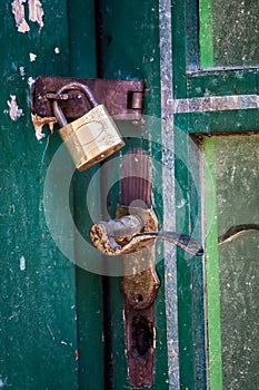 Vintage padlock handle at green door