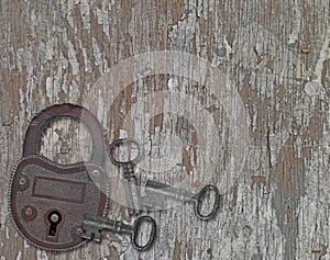 Vintage padlock on a old wooden panel