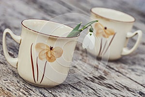 Vintage painted coffee cup on old wooden table