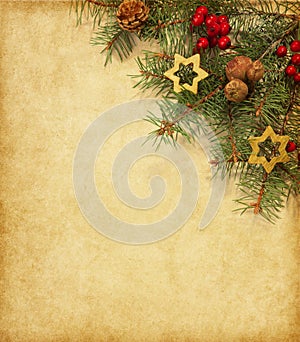 Vintage paper with spruce branch adorned with Christmas decorations