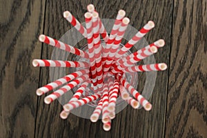 Vintage paper straws in glass on wood table