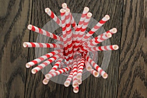 Vintage paper straws in glass on wood table photo