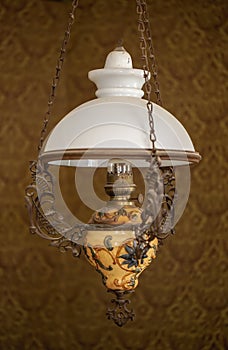Vintage petroleum lamp hanging indoor from the ceiling