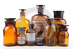 Vintage pharmacy bottles on white background