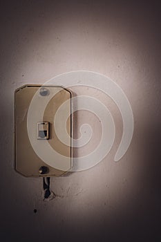 Vintage phone jack wall mount on a white wall