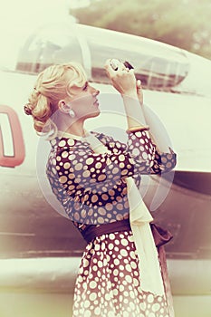 Vintage photo of beautiful girl and plane